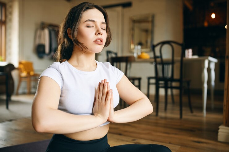 woman meditating - spiritual meanings of ringing in right ear