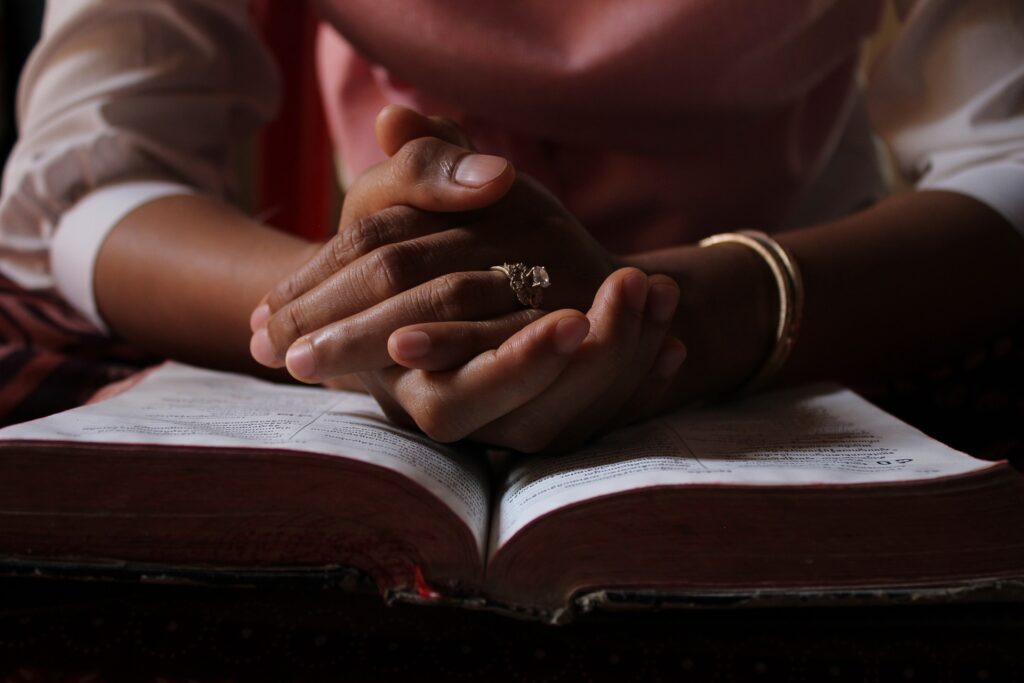 woman reading bible - spiritual awakening signs