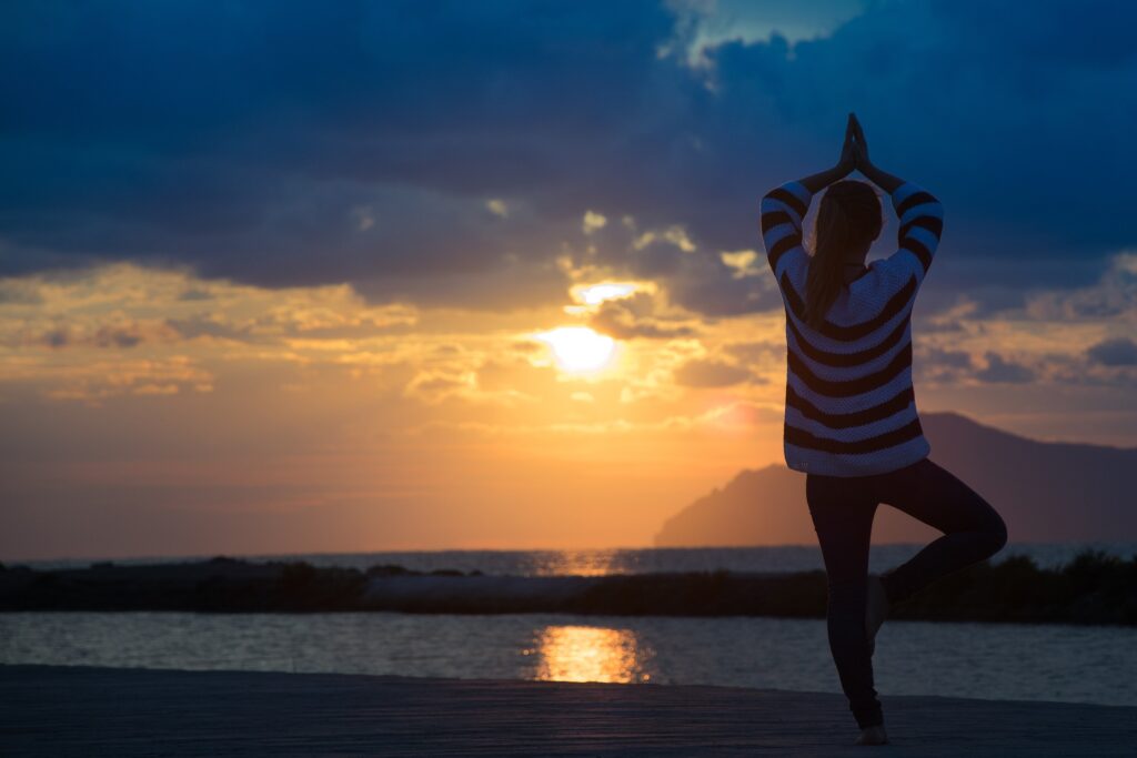 woman doing yoga in sunset - Yellow Jacket Spiritual Meaning