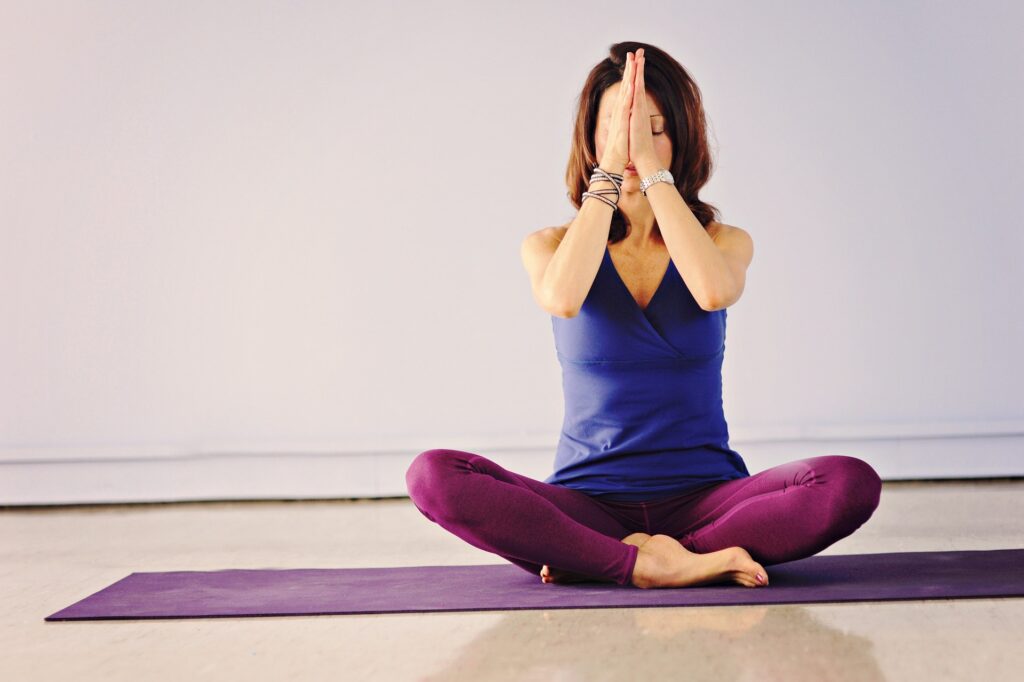 woman doing yoga - spiritual awakening signs