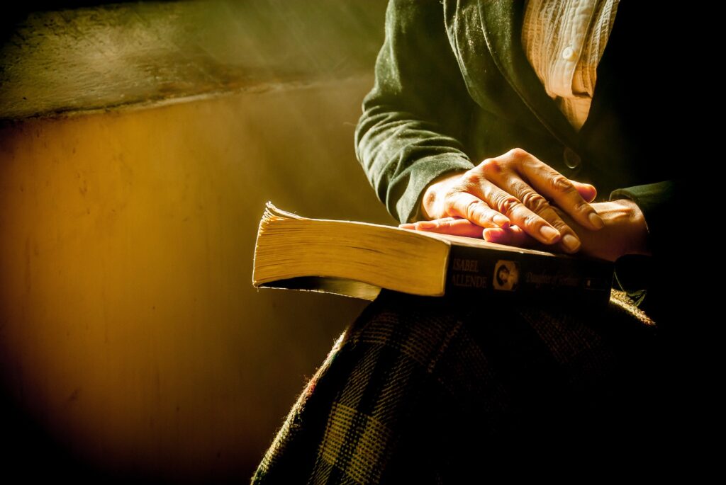 man holding a bible - Spiritual Meanings of Seeing a Plane