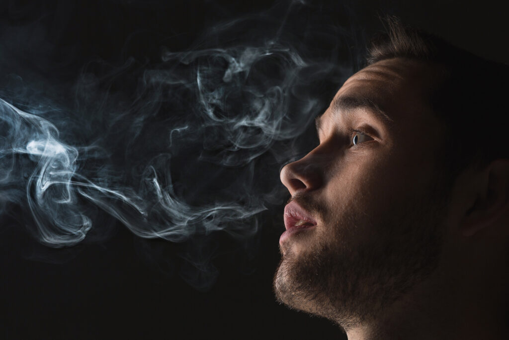 man smoking - spiritual meanings of smelling smoke