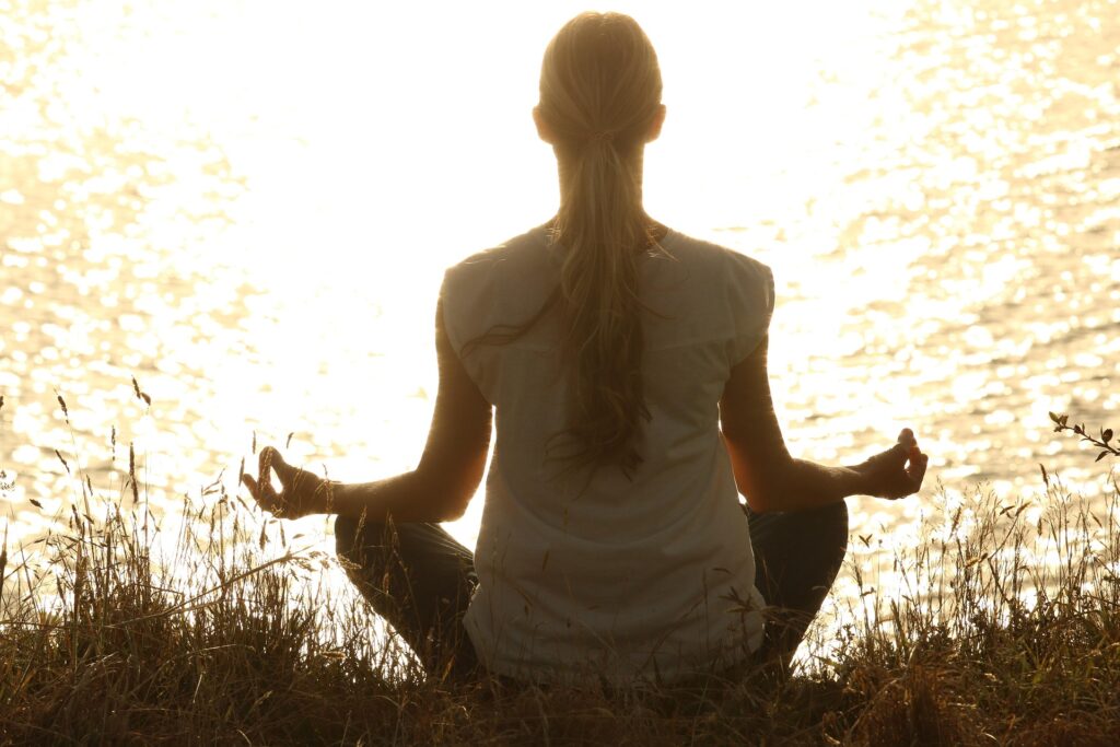 woman meditating - Spiritual Meanings of Crows